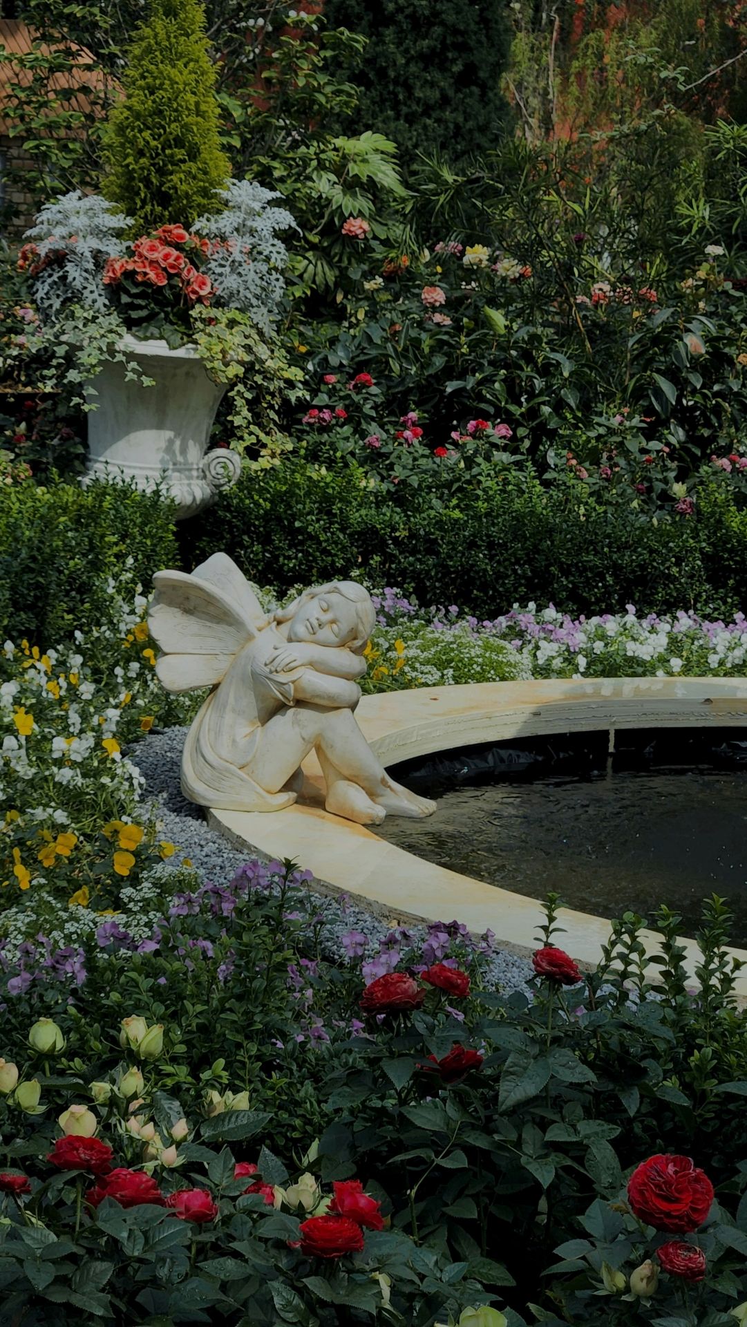 Stone Fairy sits on a curved wooden bench evoking the poet Percy Shelley