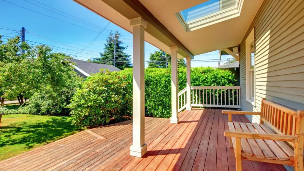 Sparse back porch with plain wooden garden bench